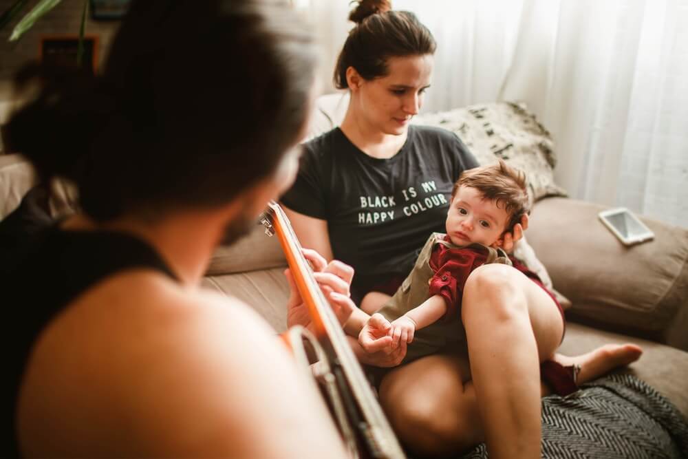 woman playing with toddler on a reclining sofa